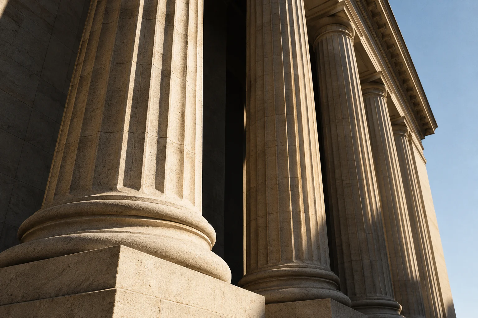Classical stone columns with deep shadows